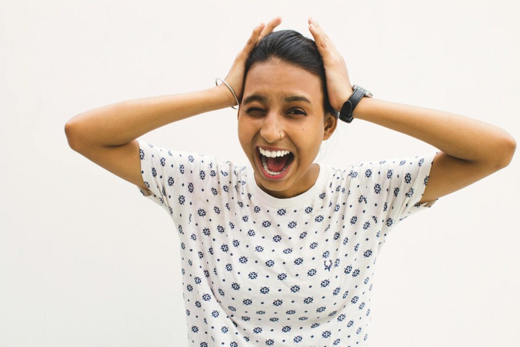 Woman holding her head between her hands hysterically in stress