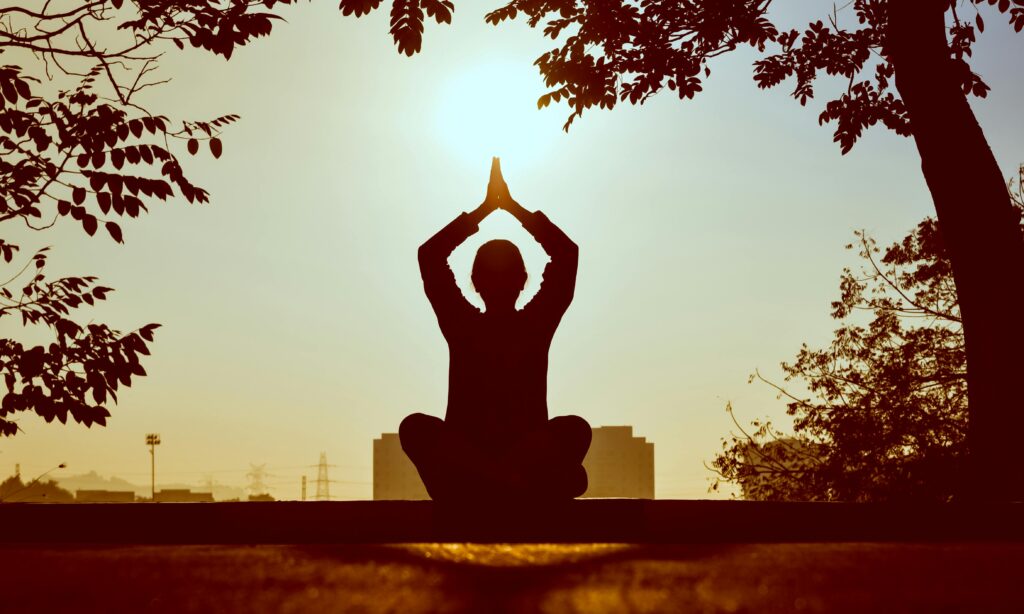 A Yogic woman's silhoutte in the sun